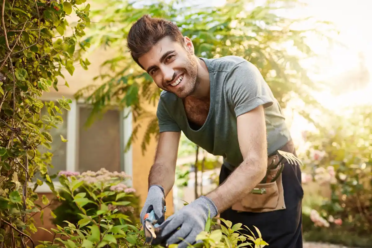 man in garden gloves working in Dutch backyard