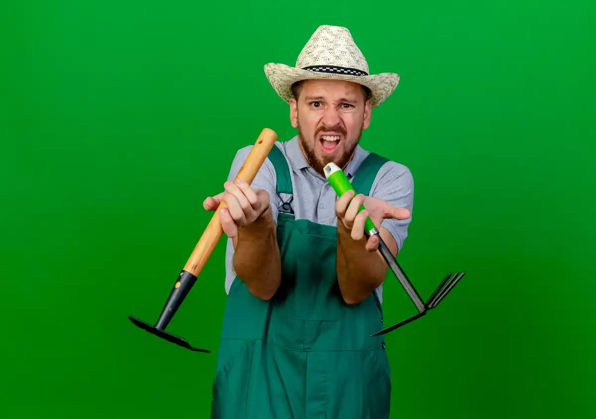 dutch gardener holding hoe upside down allotment