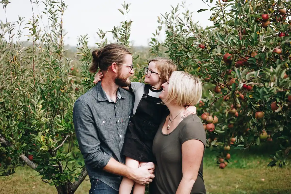 happy dutch family harvesting plums garden