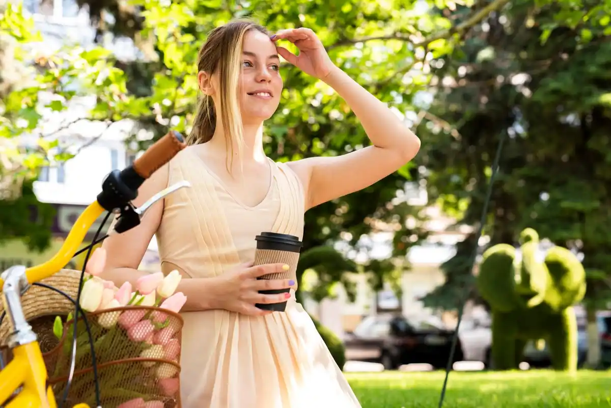 Dutch woman pouring coffee grounds in flower bed