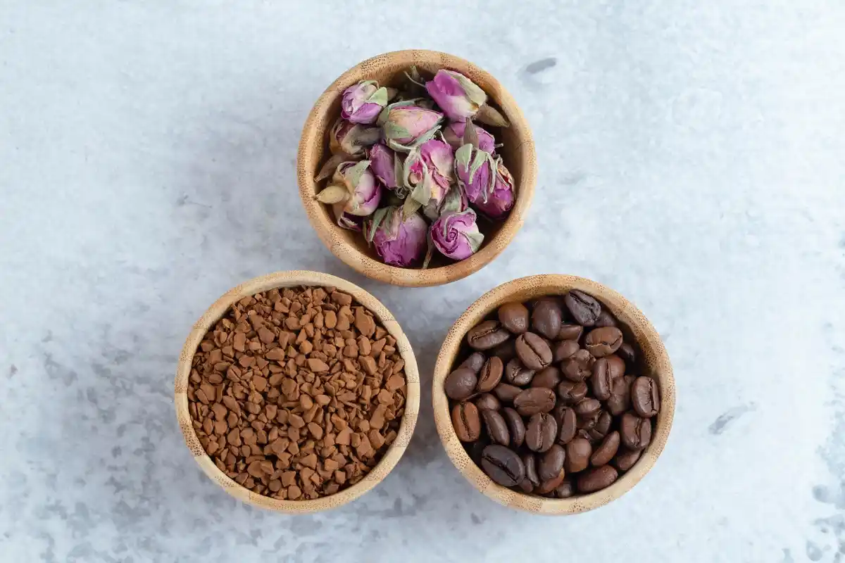 Close up of coffee grounds mixed with soil in flower garden