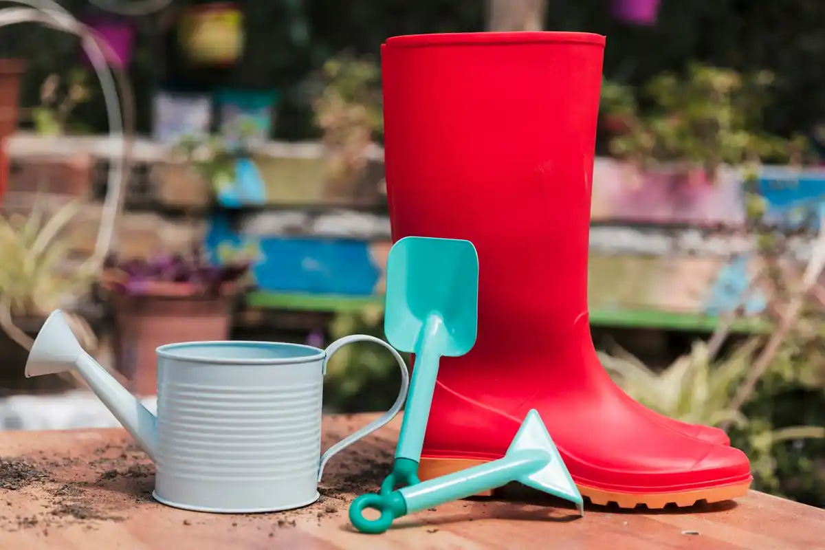 WD-40 bottle with garden tools on Dutch grass
