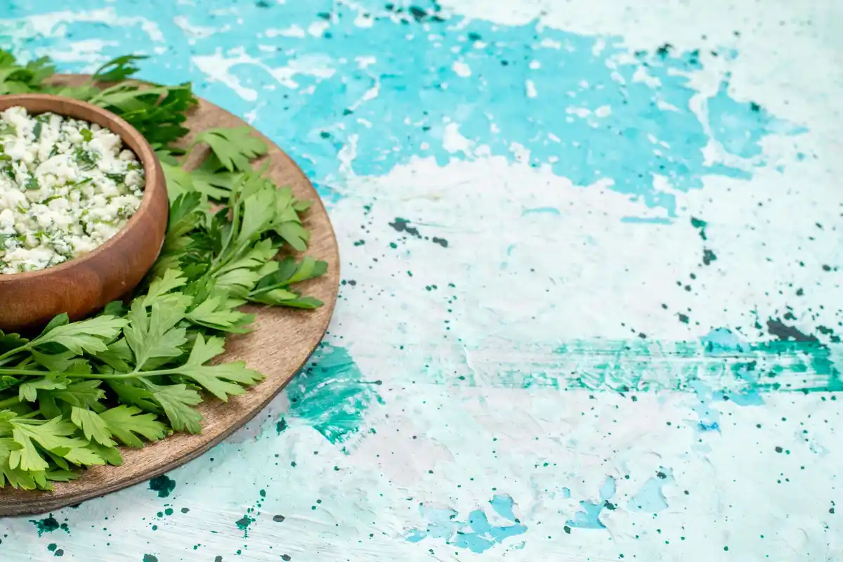 chopped parsley sprinkled with salt on wooden cutting board
