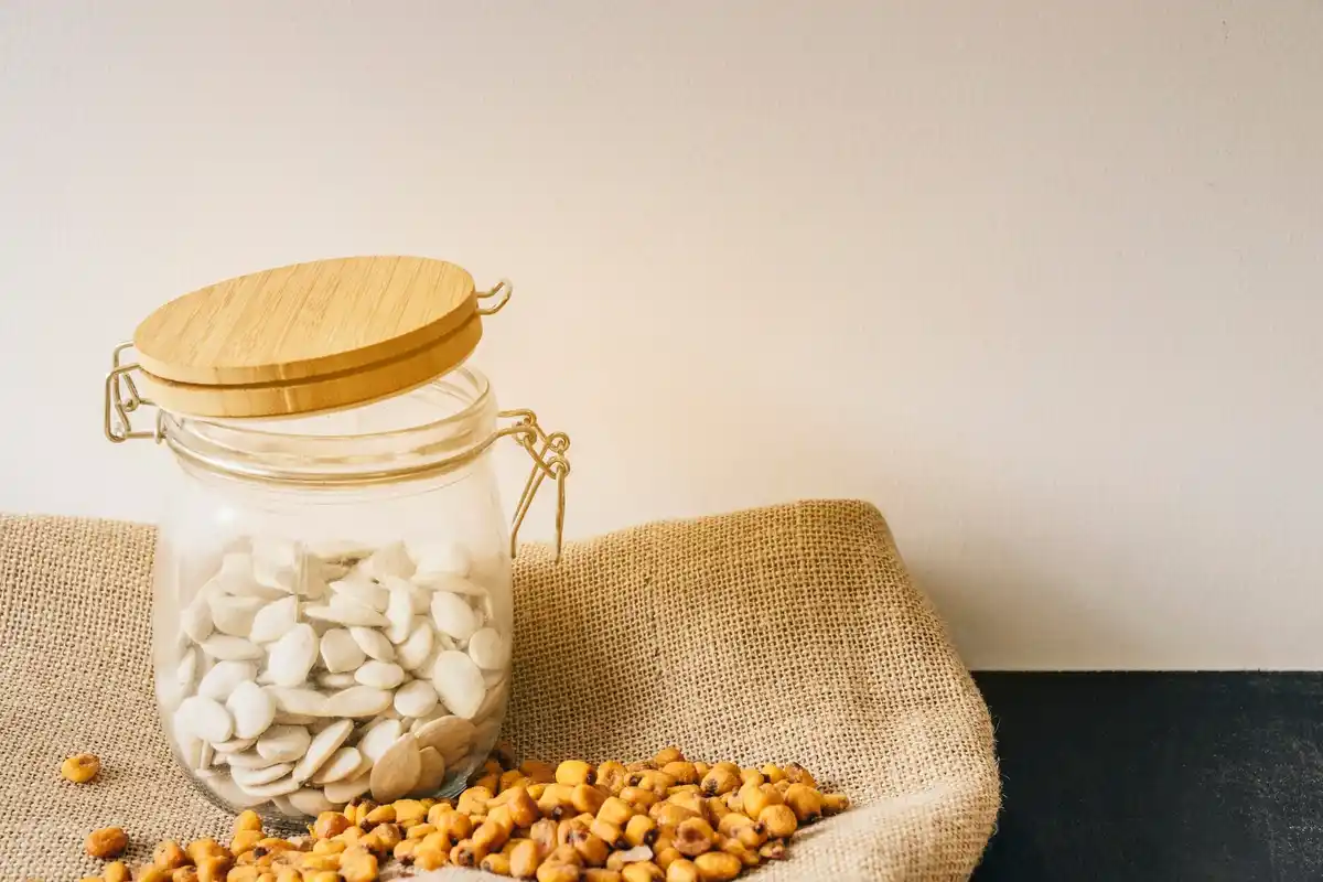glass jar labelled seeds inside freezer