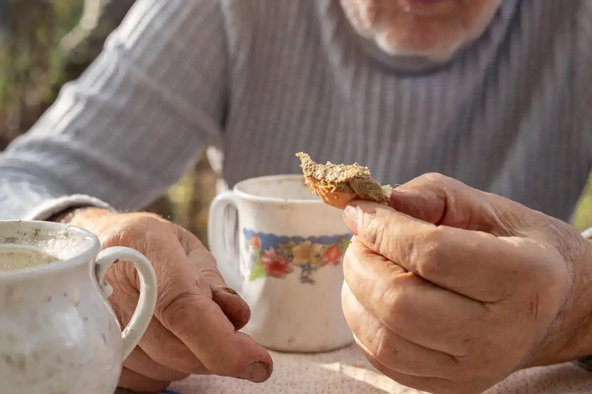 dutch grandma hands soaking seeds in bowl rustic kitchen