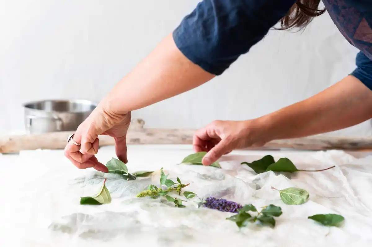 hands crushing eggshells near rose bush