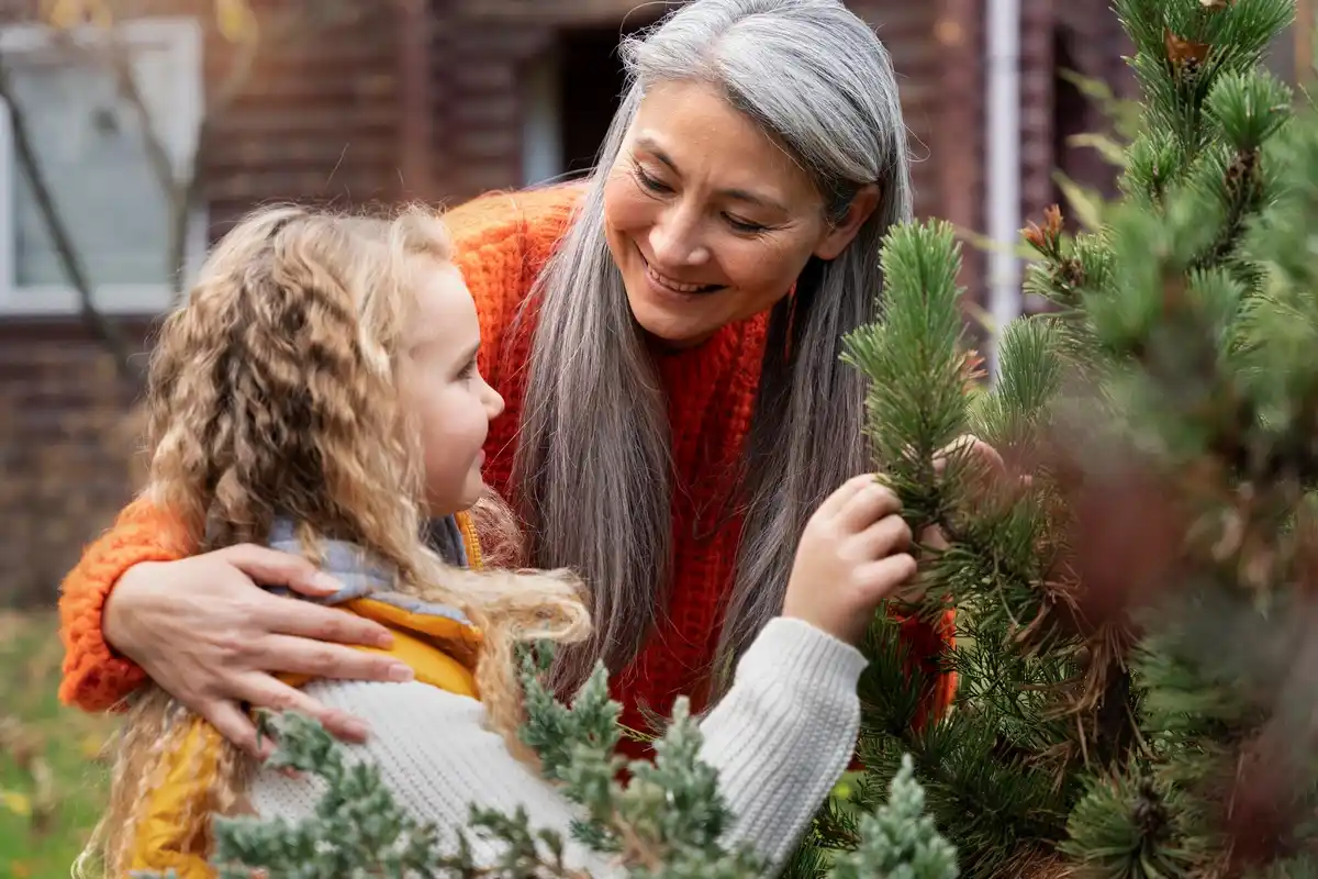 elderly dutch woman gardening with grandchildren may backyard