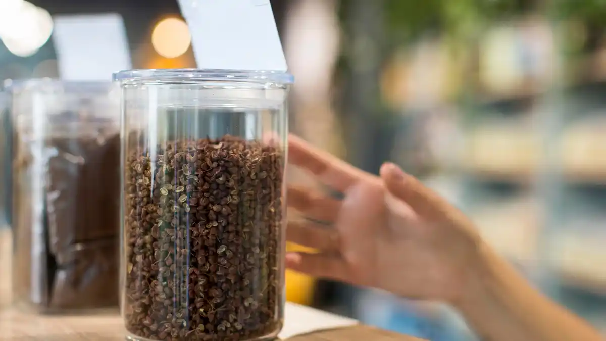 coffee grounds being sprinkled on Dutch garden soil