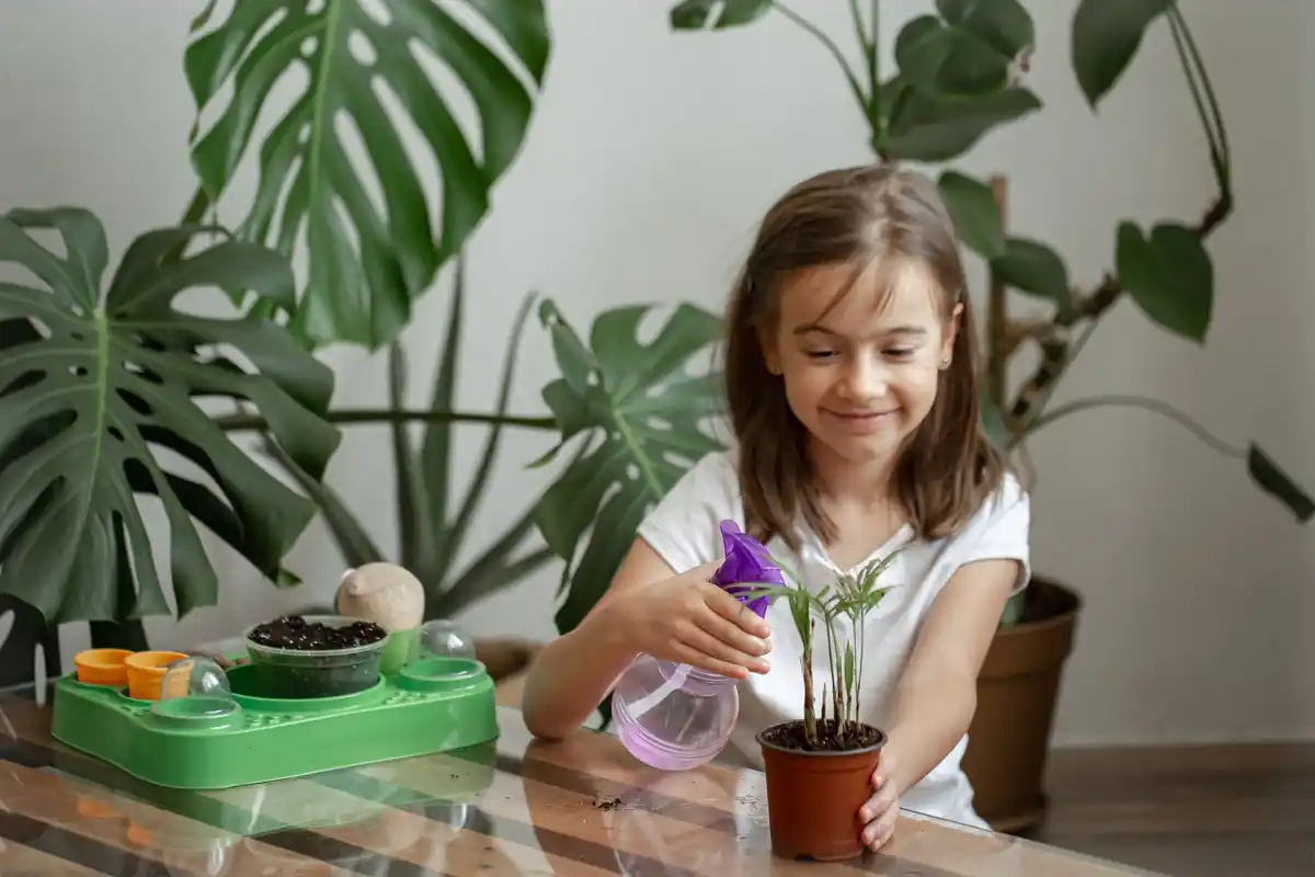 child gardening at home with recycled materials