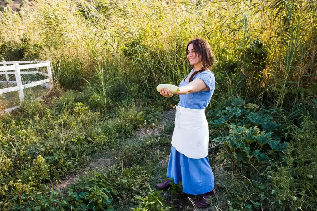 dutch gardener using tablespoon in spring garden