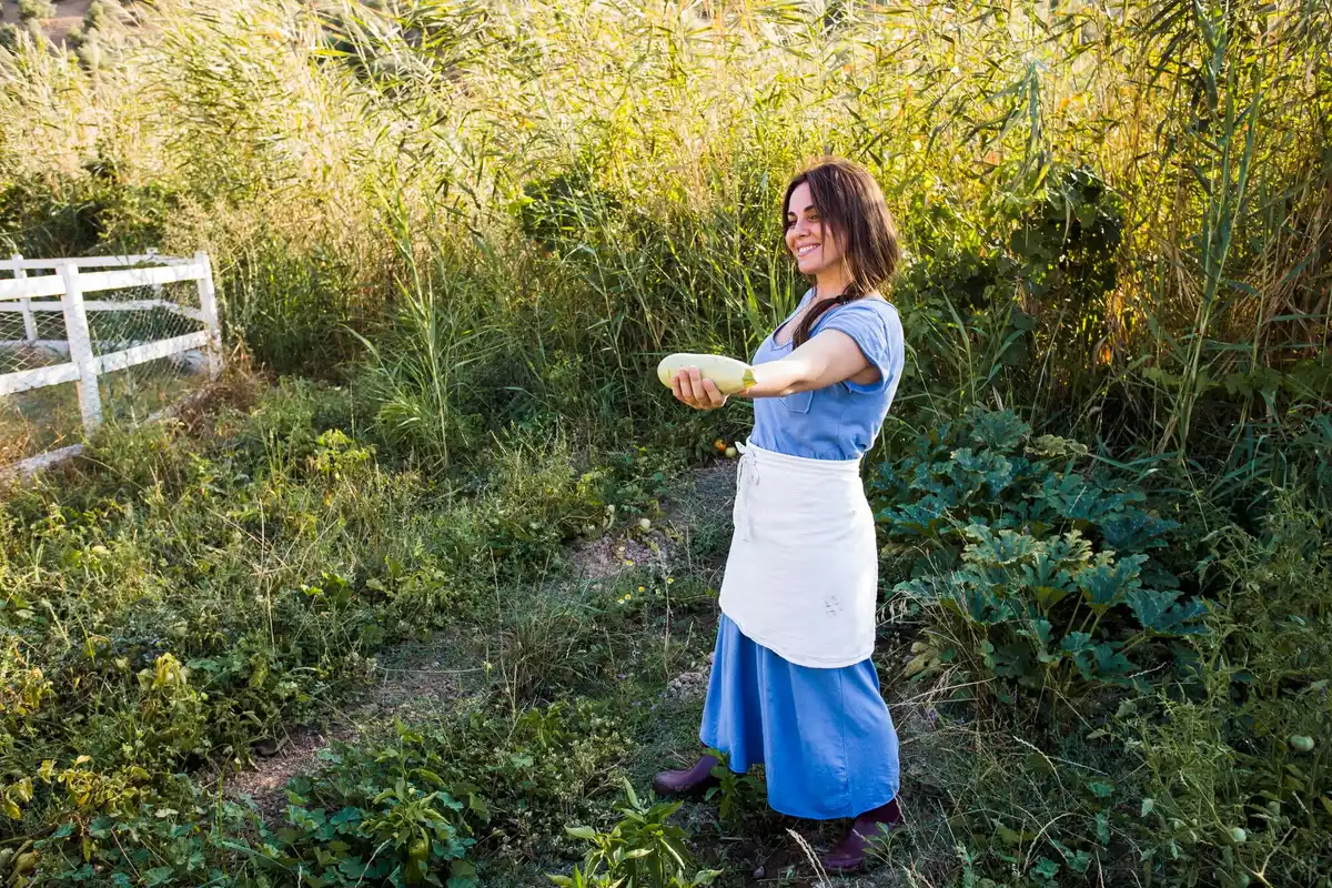 dutch gardener using tablespoon in spring garden