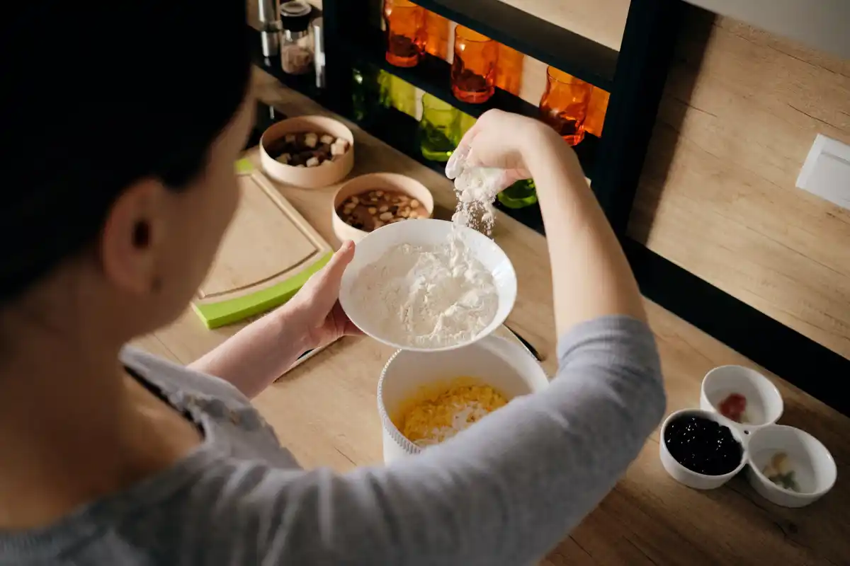 someone adding expensive seeds to breakfast in dutch kitchen